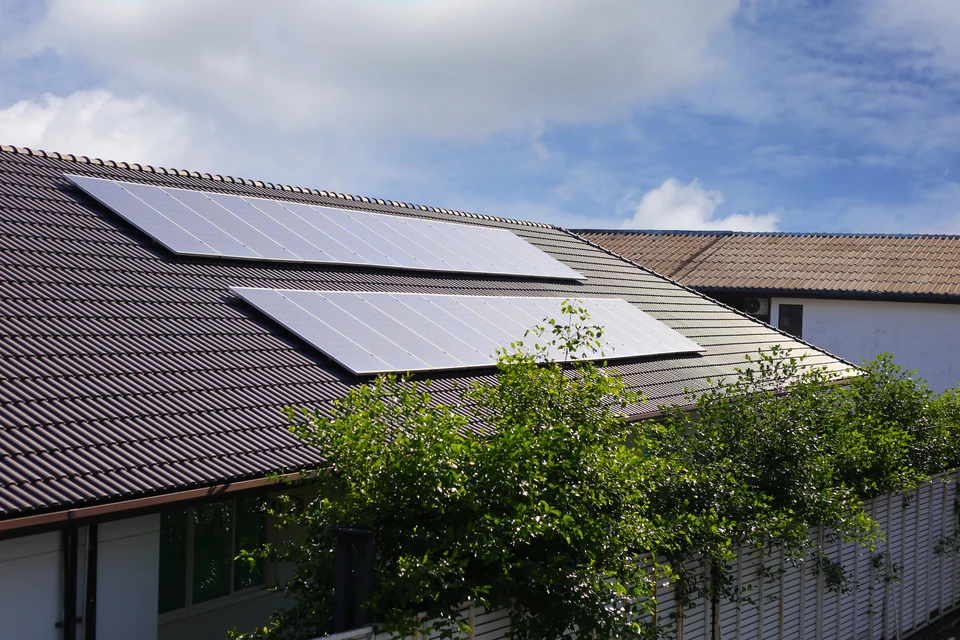 Maison résidentielle avec toiture en tuiles rouges équipée de panneaux solaires photovoltaïques